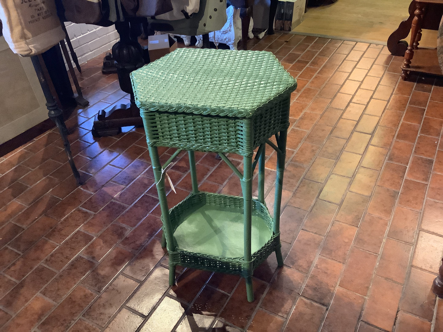 641. Green wicker accent table