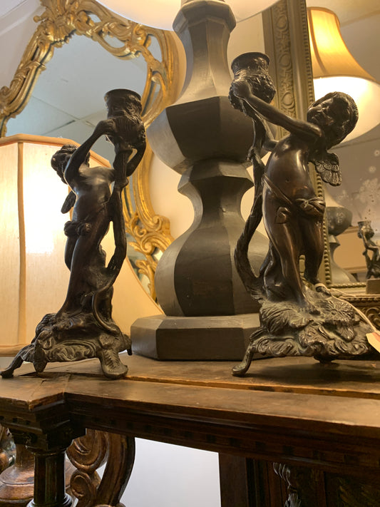 299. Bronze cherub candlesticks